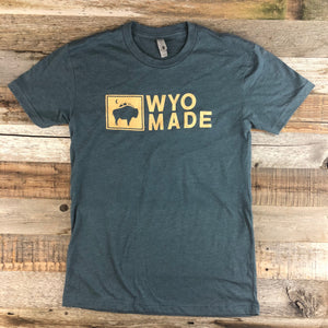 WyoMade Logo Tee | Unisex  The reinvented WyoMade Apparel Logo is a modern twist on our long time iconic design from WyoMade Apparel!   The Bison represents freedom and is a staple of Wyoming's open spaces. This Indigo colored T-shirt is sure to appease your desire to roam free.  Be a part of the herd in a comfy WyoMade Logo T-Shirt deigned for both men and women.  Offering sizes ranging from:  X-Small Small Medium Large Extra Large - XL Double Extra Large - XXL
