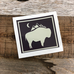 The New Bison Moon is a modern twist on our long time iconic design from WyoMade!   The Bison represents freedom and is a staple of Wyoming's open spaces. This sticker is sure to appease your desire to roam free.  Be a part of the herd with the Bison Moon design, squared up, from Wyomade.     Size:  2.6" x 3"